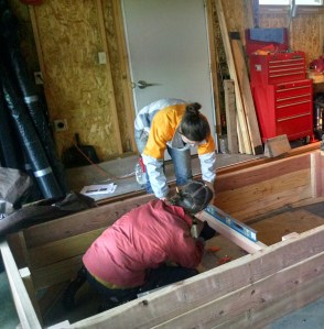 Elise D’Alessandro and Amanda Harper construct a raised bed.
